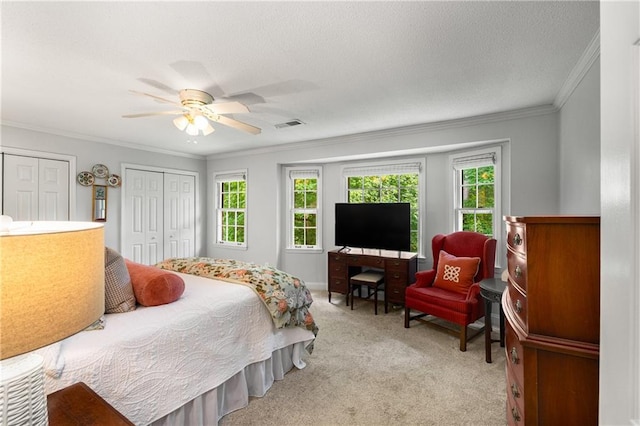 2349 Northlake Ct NE, Atlanta, GA 30345 - carpeted bedroom with multiple windows, ornamental molding, two closets, and ceiling fan
