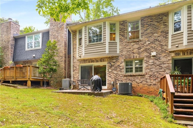 2349 Northlake Ct NE, Atlanta, GA 30345 - back of house featuring a chimney, a deck, a lawn, and central AC
