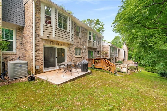 2349 Northlake Ct NE, Atlanta, GA 30345 - back of property with central AC, a yard, brick siding, a patio area, and a deck