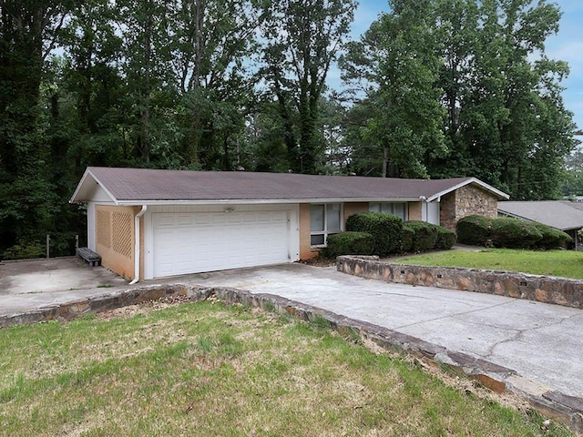 4135 Sunrise Trl, Atlanta, GA 30349 - ranch-style house with an attached garage, driveway, and a front yard