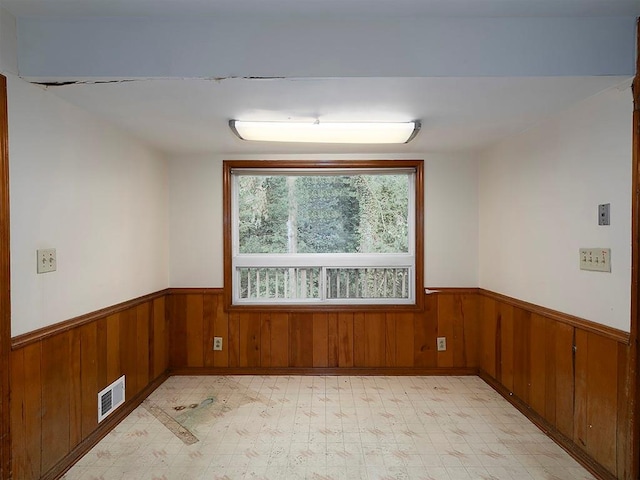 4135 Sunrise Trl, Atlanta, GA 30349 - unfurnished room with wainscoting, wooden walls, and light floors