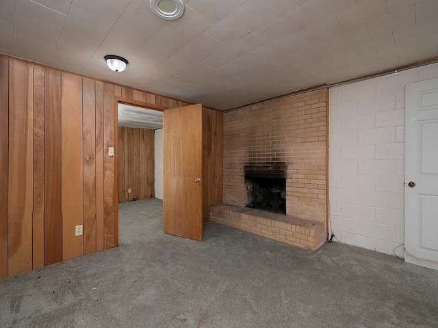 4135 Sunrise Trl, Atlanta, GA 30349 - unfurnished living room featuring carpet, a brick fireplace, and wooden walls