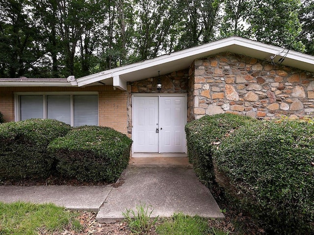 4135 Sunrise Trl, Atlanta, GA 30349 - view of front facade featuring an attached garage, stone siding, and a front yard