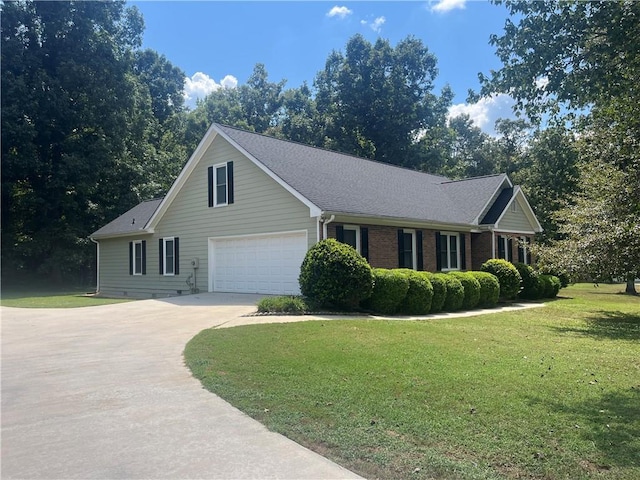 view of front of house featuring a front yard and a garage