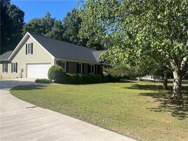 view of front of property with a garage and a front lawn