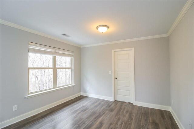 empty room with crown molding and dark hardwood / wood-style floors