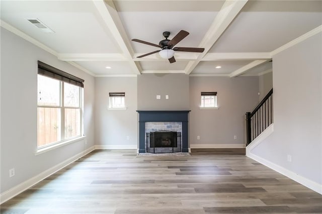 unfurnished living room featuring coffered ceiling, wood-type flooring, crown molding, beamed ceiling, and ceiling fan