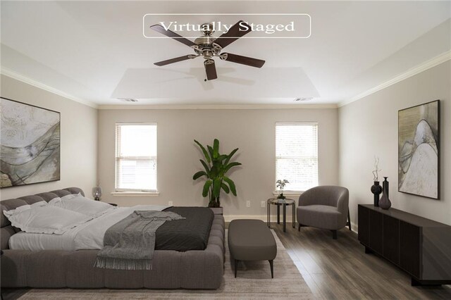 bedroom featuring ceiling fan, dark wood-type flooring, ornamental molding, and a raised ceiling