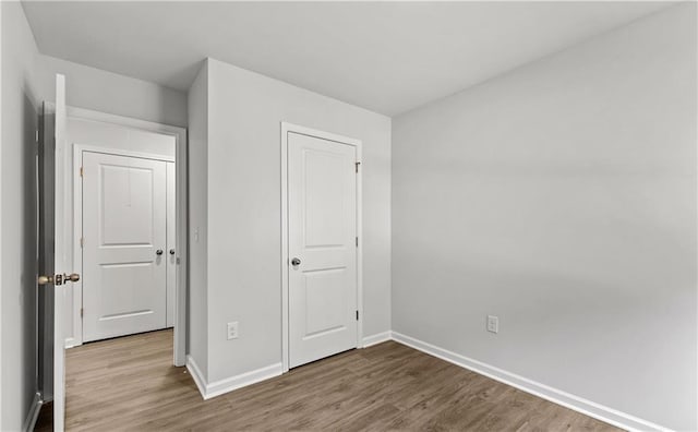 unfurnished bedroom with hardwood / wood-style floors