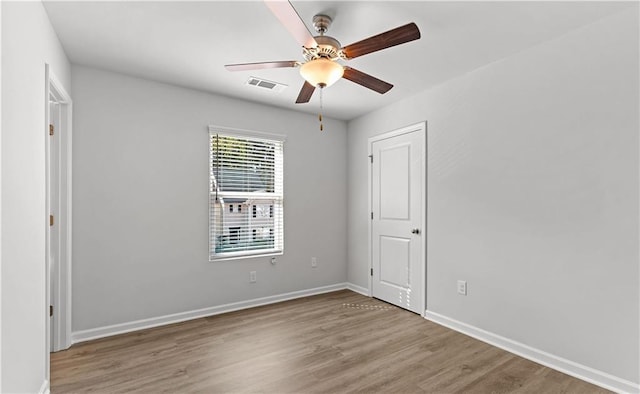 empty room with hardwood / wood-style flooring and ceiling fan