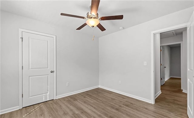 empty room with hardwood / wood-style flooring and ceiling fan