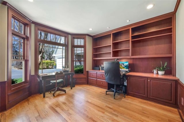 office area with built in features, a wainscoted wall, light wood-style flooring, recessed lighting, and ornamental molding