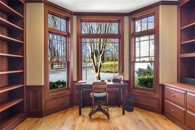 office space with a wainscoted wall and light wood-style flooring