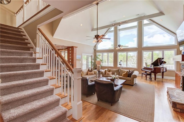 1126 Shoreline Dr, Jefferson, GA 30549 - living area with ceiling fan, stairway, light wood finished floors, and high vaulted ceiling