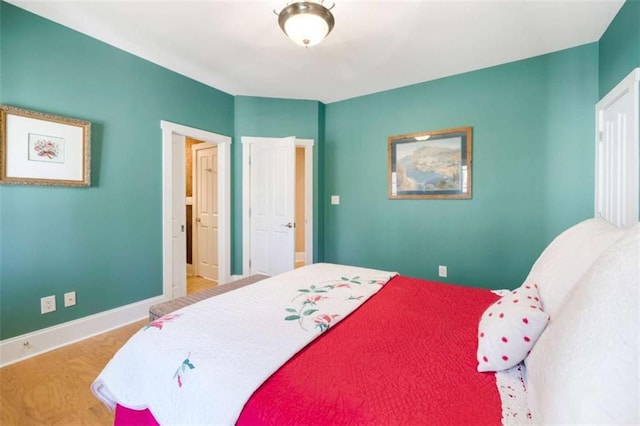 bedroom with baseboards and wood finished floors