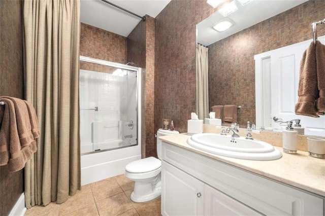 full bath featuring tile patterned flooring, toilet, vanity, and enclosed tub / shower combo