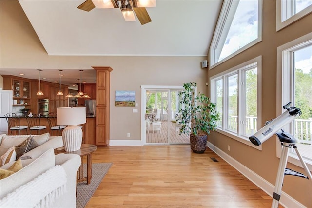 1126 Shoreline Dr, Jefferson, GA 30549 - living room with a ceiling fan, high vaulted ceiling, light wood-style flooring, and baseboards