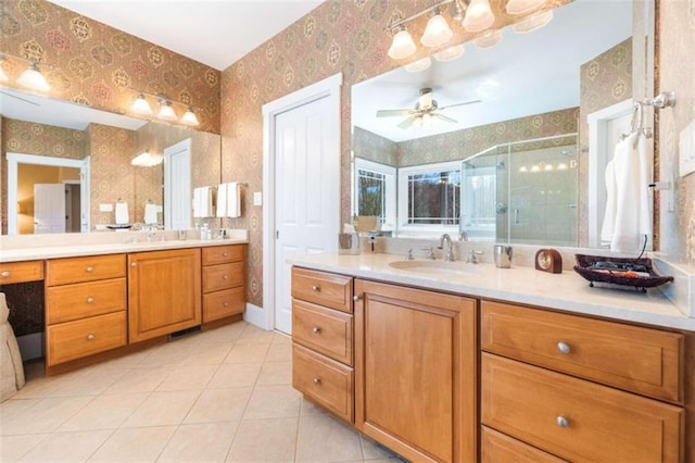 full bath featuring wallpapered walls, two vanities, ceiling fan, a sink, and a shower stall