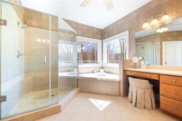 bathroom featuring a bath, a stall shower, wallpapered walls, and a ceiling fan