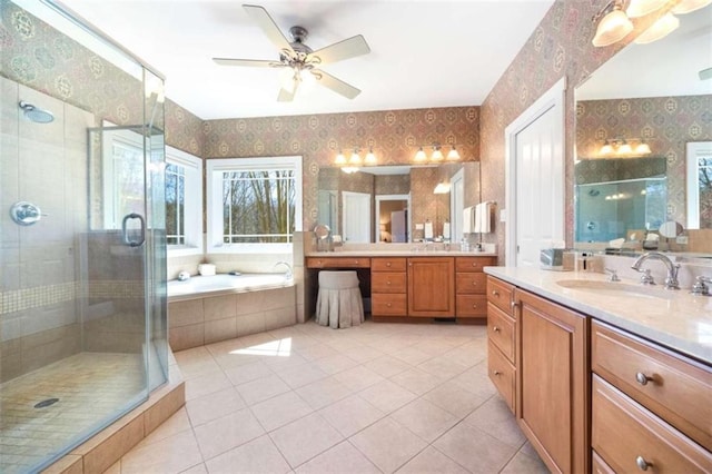 bathroom featuring wallpapered walls, a stall shower, tile patterned flooring, a ceiling fan, and a sink