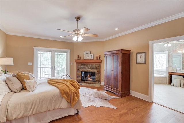 1126 Shoreline Dr, Jefferson, GA 30549 - bedroom with access to exterior, crown molding, light wood-style floors, a fireplace, and baseboards
