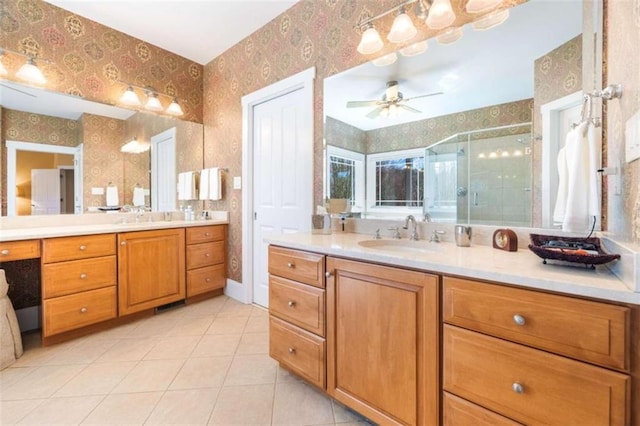 bathroom featuring two vanities, wallpapered walls, tile patterned floors, a shower stall, and a sink