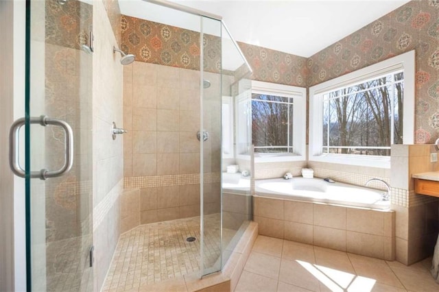 bathroom with wallpapered walls, tile patterned floors, a bath, and a shower stall