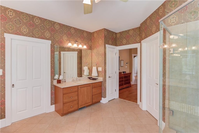 1126 Shoreline Dr, Jefferson, GA 30549 - full bath featuring wallpapered walls, vanity, tile patterned flooring, ceiling fan, and a stall shower