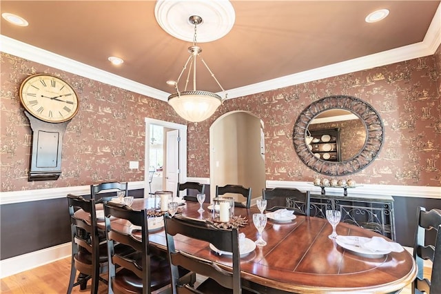 1126 Shoreline Dr, Jefferson, GA 30549 - dining space with wainscoting, wood finished floors, wallpapered walls, ornamental molding, and arched walkways