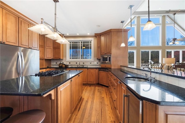 1126 Shoreline Dr, Jefferson, GA 30549 - kitchen with appliances with stainless steel finishes, a sink, light wood finished floors, brown cabinets, and wine cooler