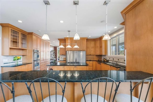 kitchen with a large island, recessed lighting, a kitchen breakfast bar, and stainless steel appliances