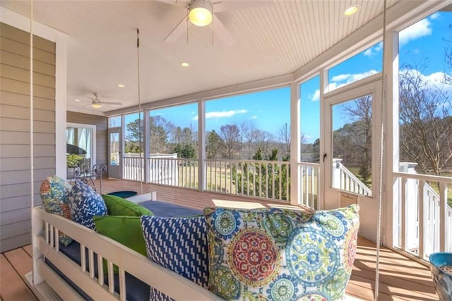 sunroom / solarium featuring a healthy amount of sunlight and ceiling fan