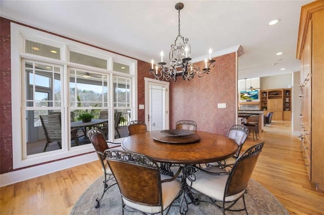 dining area featuring ornamental molding, recessed lighting, light wood-style floors, an inviting chandelier, and baseboards