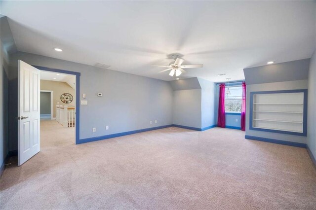 interior space featuring recessed lighting, ceiling fan, built in shelves, and baseboards