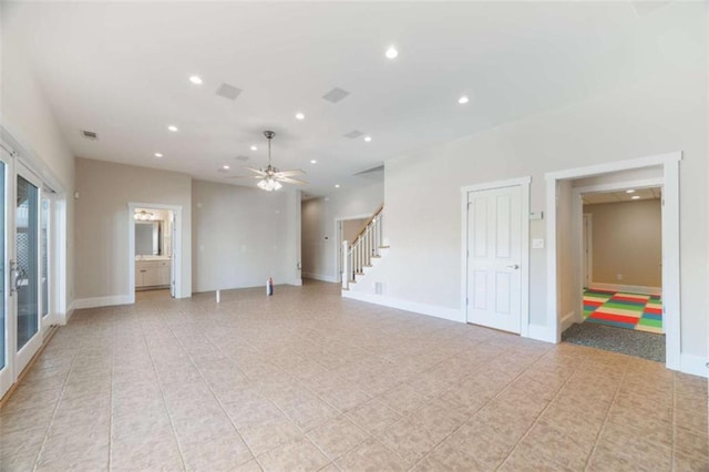 empty room featuring a ceiling fan, visible vents, baseboards, recessed lighting, and stairs