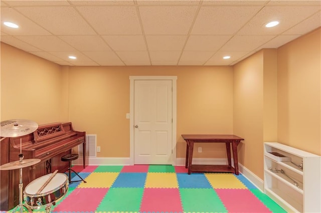 recreation room with a paneled ceiling, baseboards, recessed lighting, tile patterned floors, and visible vents