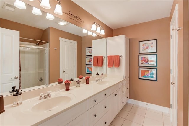 1126 Shoreline Dr, Jefferson, GA 30549 - bathroom featuring double vanity, tile patterned flooring, an enclosed shower, and baseboards
