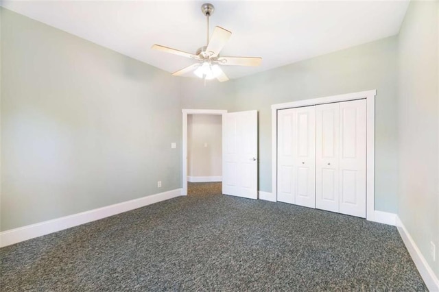 unfurnished bedroom featuring a closet, ceiling fan, baseboards, and dark colored carpet