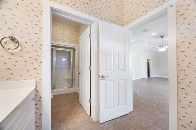 corridor with light tile patterned floors and wallpapered walls