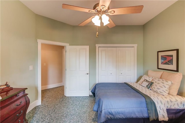 carpeted bedroom featuring a closet, baseboards, and a ceiling fan