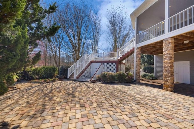 view of side of home featuring stairs