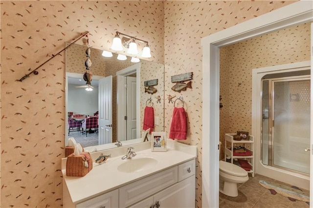 bathroom featuring vanity, wallpapered walls, tile patterned flooring, toilet, and a shower stall