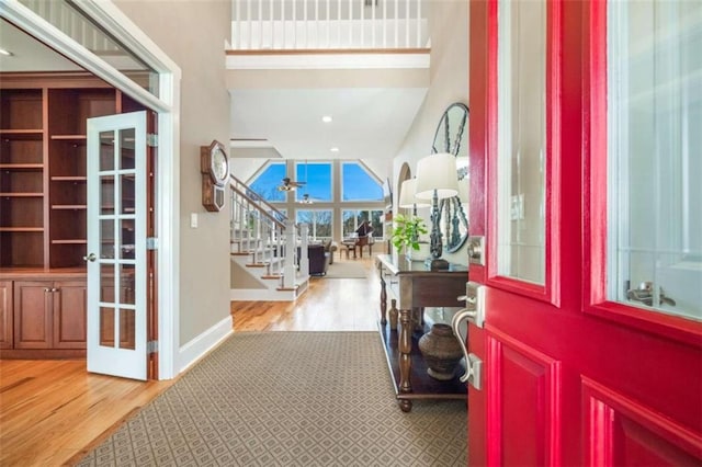 entrance foyer with stairway, recessed lighting, wood finished floors, and baseboards