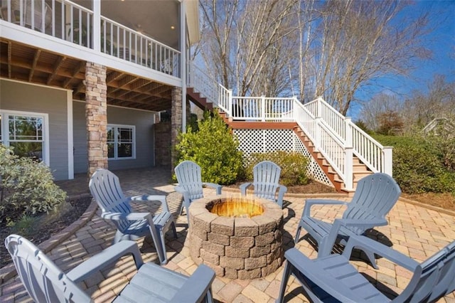 view of patio / terrace featuring stairway and a fire pit