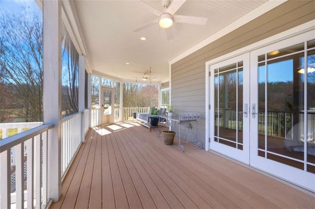 deck with a ceiling fan and french doors