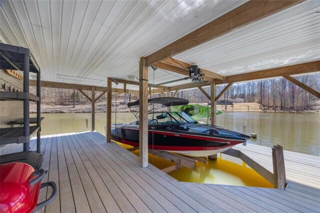 view of dock with boat lift and a water view