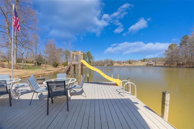 dock area with a water view and an outdoor fire pit