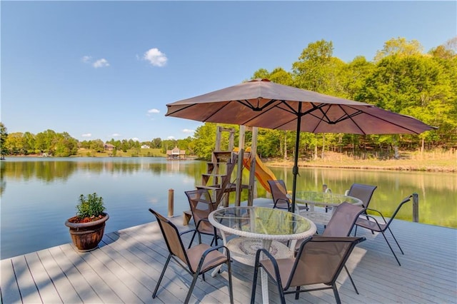 dock area featuring a water view and outdoor dining space
