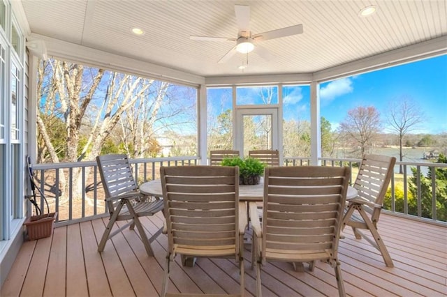 sunroom / solarium featuring ceiling fan