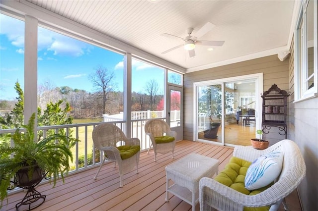 sunroom / solarium featuring ceiling fan